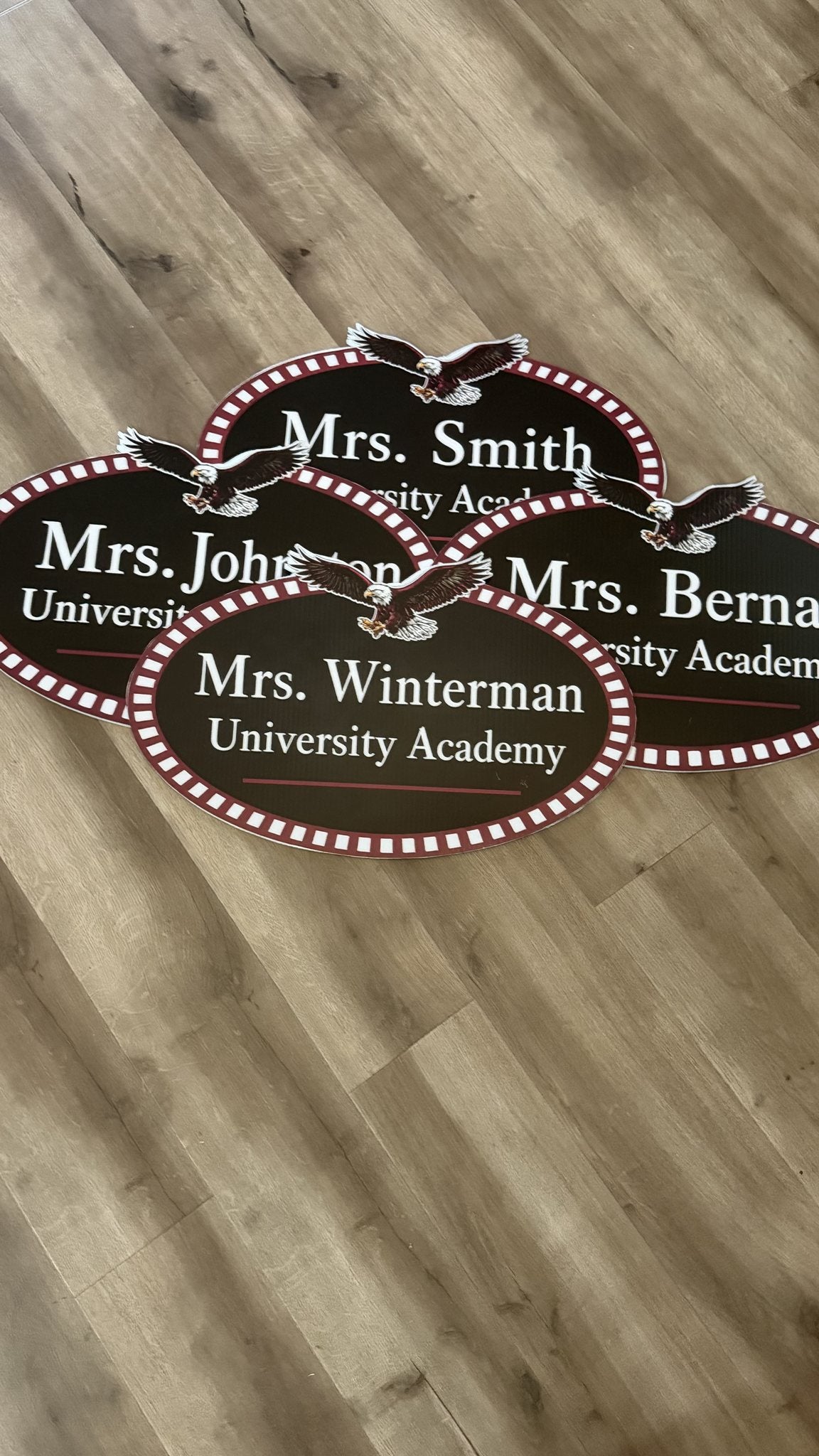Die-cut oval coroplast teacher name signs for a school