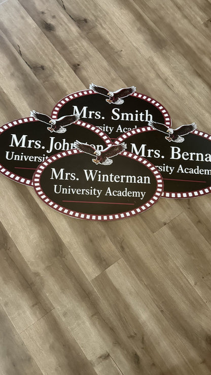 Die-cut oval coroplast teacher name signs for a school